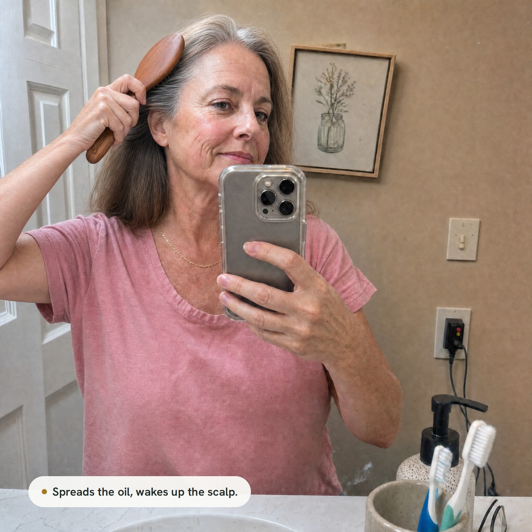 A woman brushing her hair with the AirTouch Brush in her bathroom