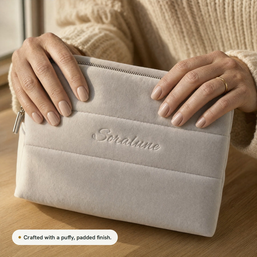 Hands pressing the puffy, padded finish of the Puffy Beauty Bag