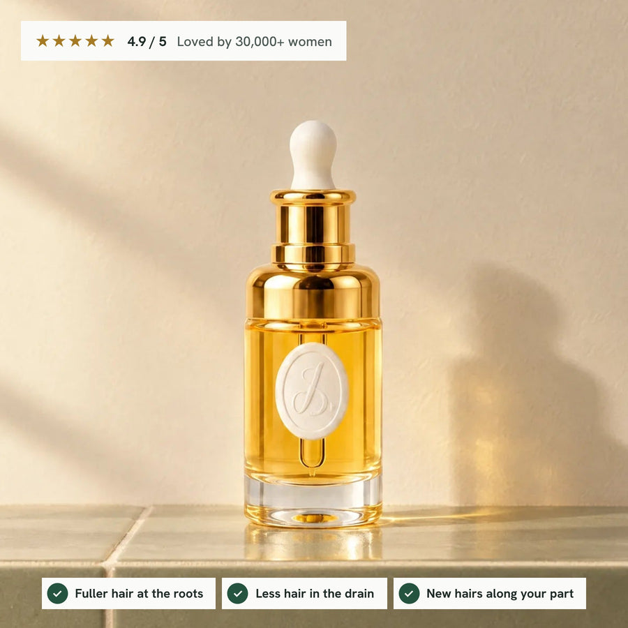Lumina Oil bottle on a sage tile ledge in warm sun, rated 4.9 out of 5